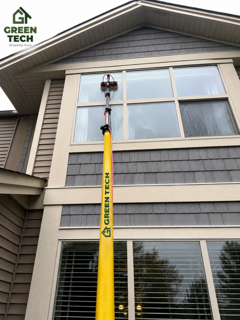 Greentech team cleaning exterior window